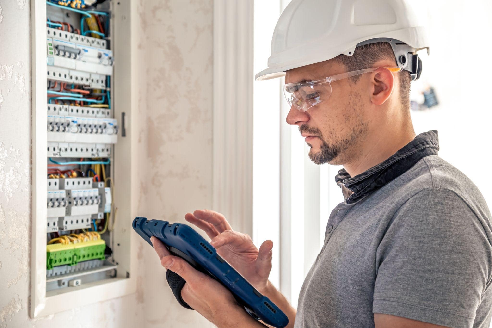 Image illustrating a professional New York electrician working on a switchboard