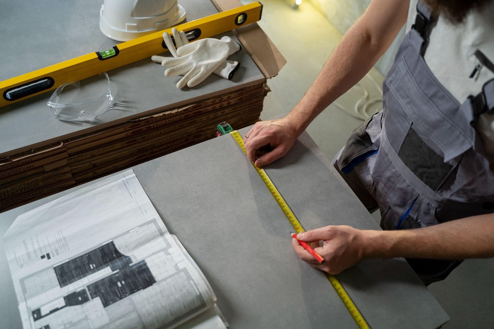 Image illustrating a tiler working on the interior remodeling of a property in New York
